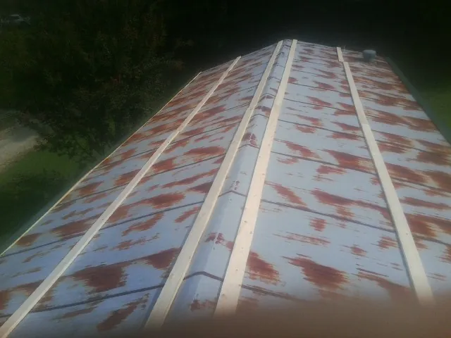 Rusted metal roof panels with new wood purlins before replacement — Storm Damage Roof Repair in Maryland Line by Roofing Brothers