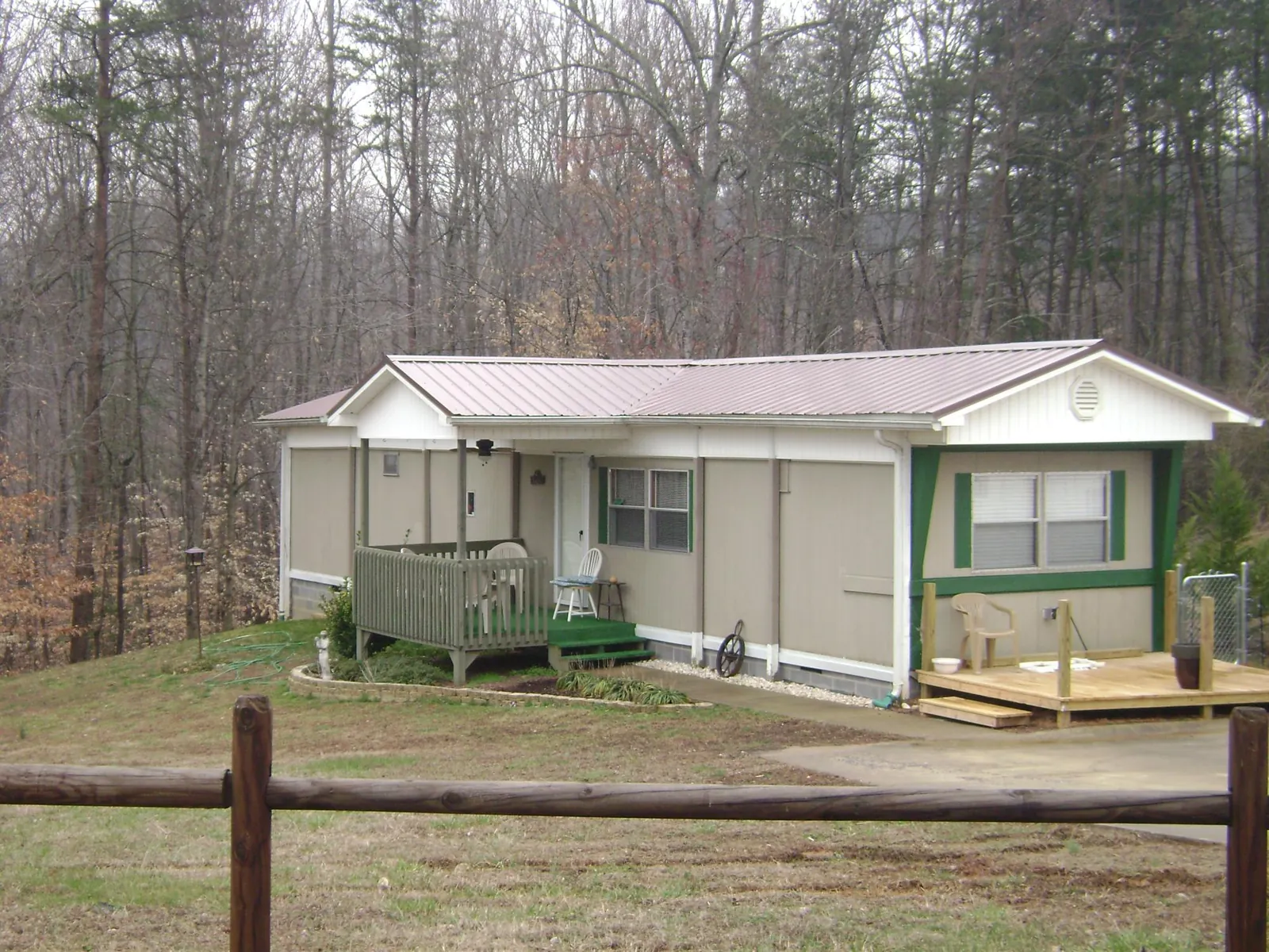 Mauve metal roof on a manufactured home with a new front deck in Maryland Line